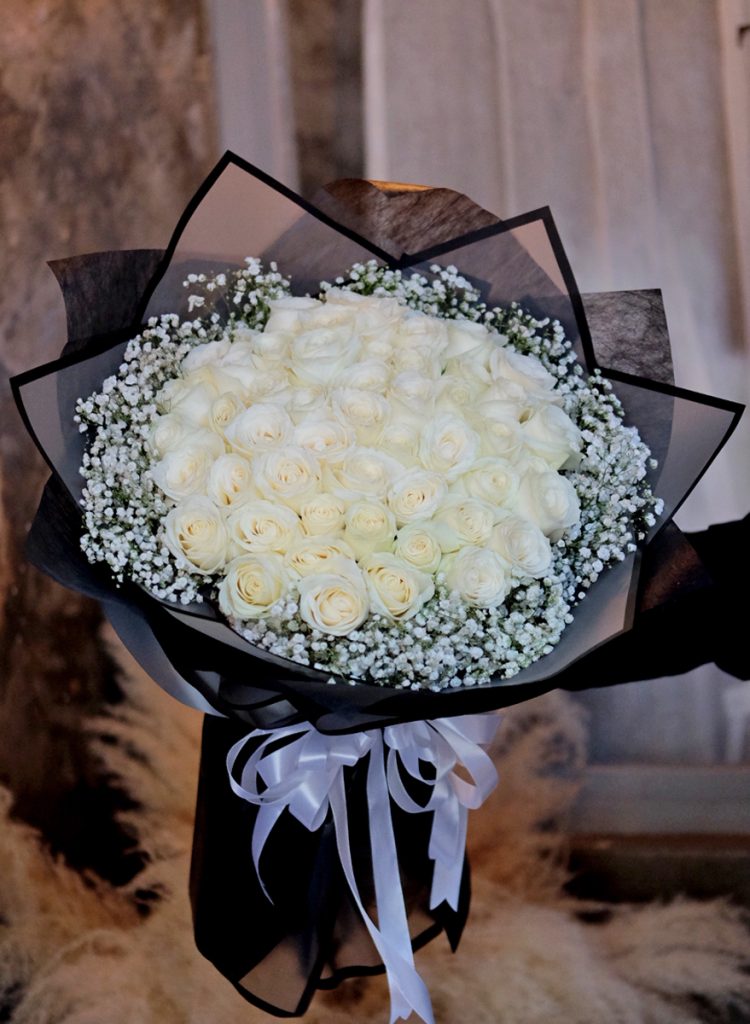 white roses hand bouquet