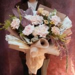 Dusty pink rose bouquet with dusky anthuriums and trailing amaranthus